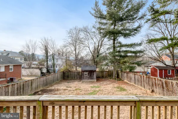 a view of wooden fence and a yard