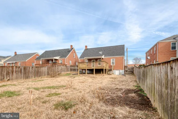 a view of a house with wooden fence