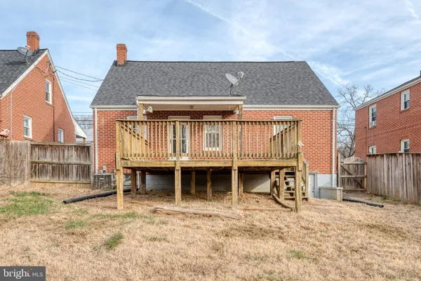 a front view of a house with a balcony and a chair