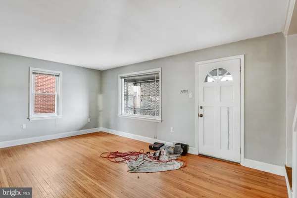 a view of a room that has a bed and wooden floor