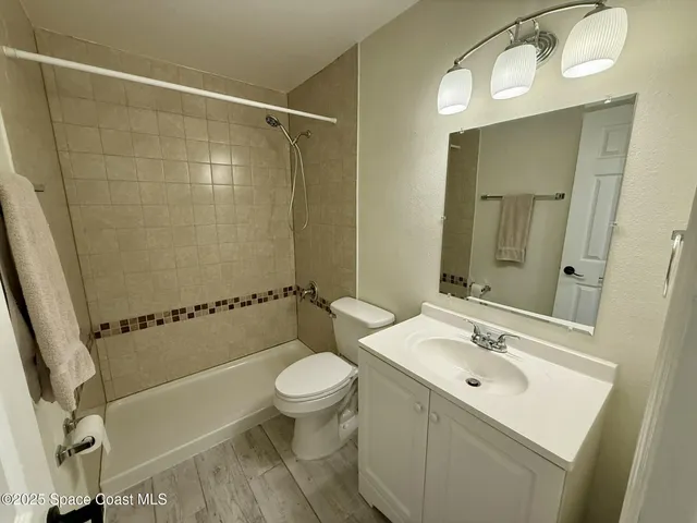 a bathroom with a sink mirror toilet and bathtub