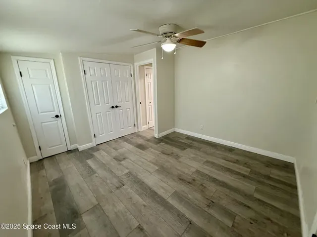a view of an empty room with a fan