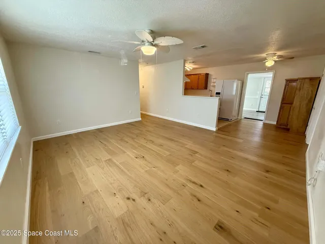 a view of a kitchen with a sink and a mirror
