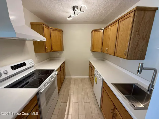 a kitchen with a sink a stove and cabinets