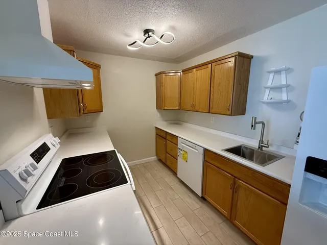 a kitchen with a sink a stove and cabinets