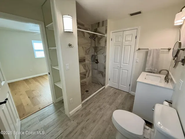 a bathroom with a toilet and a shower