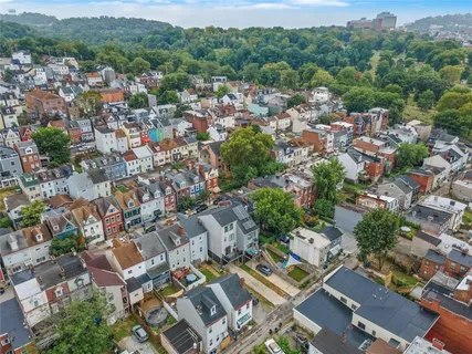 an aerial view of residential house with green space