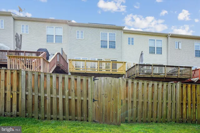 a view of a house with a big yard and large trees