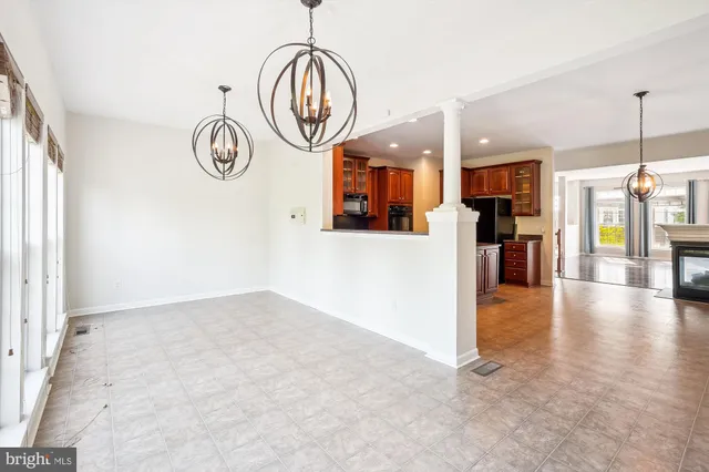 a view of empty room with window wooden floor