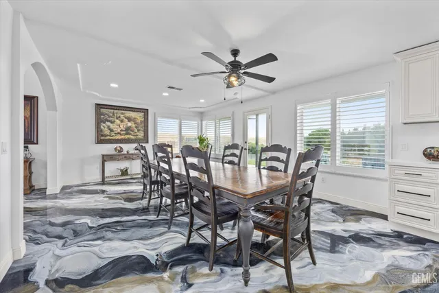 a kitchen with stainless steel appliances kitchen island granite countertop a refrigerator and a sink