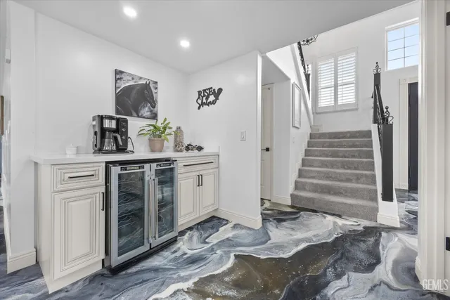 a spacious bedroom with a large bed and a dresser