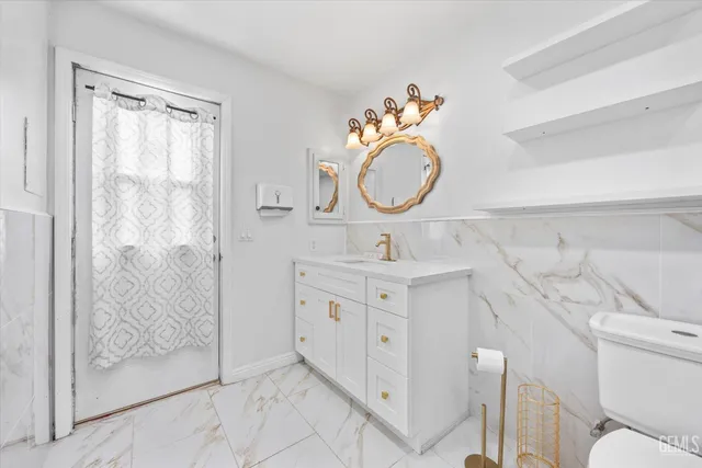 a spacious bedroom with a bed a table and chair