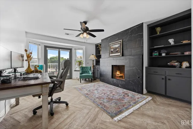 a living room with furniture a flat screen tv and a dresser