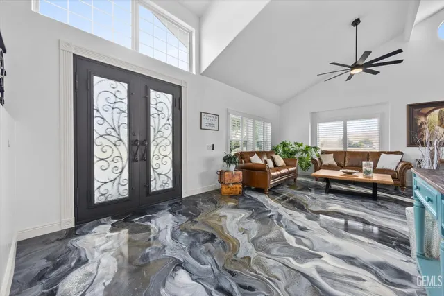 a living room with furniture a chandelier and a large window