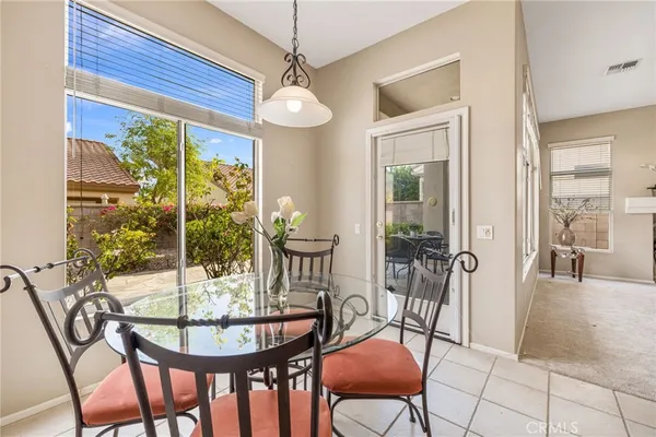a view of a dining room with furniture window and outside view