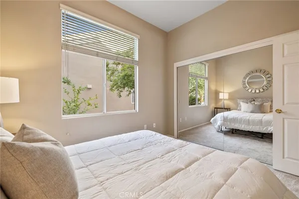 a bedroom with a large bed and a window