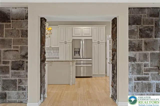a kitchen with a refrigerator and cabinets
