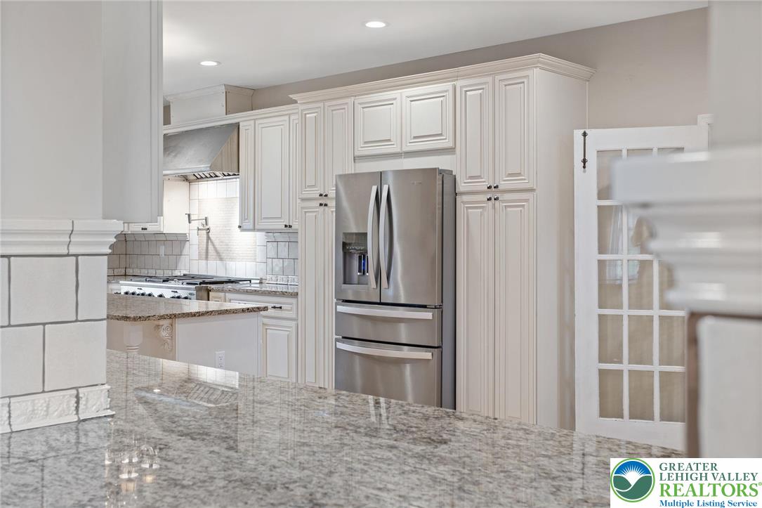 1790 Friedensville Road Bethlehem, PA 18015 - Photo 12 of 50 a kitchen with stainless steel appliances granite countertop a refrigerator and a stove top oven