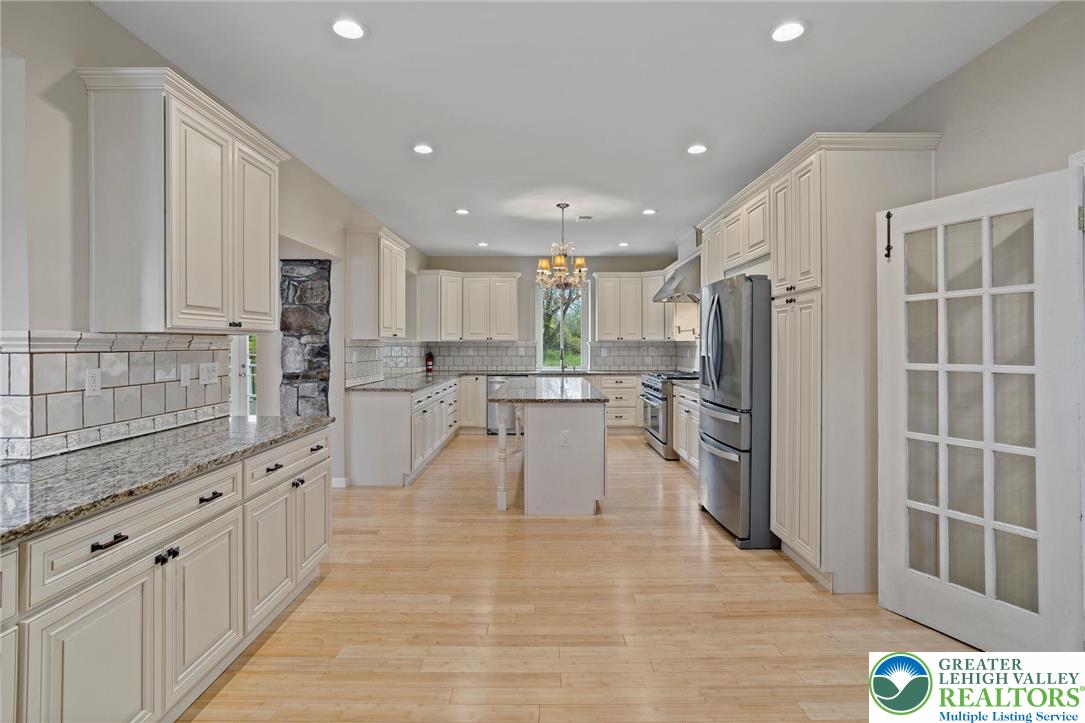 1790 Friedensville Road Bethlehem, PA 18015 - Photo 15 of 50 a large kitchen with stainless steel appliances kitchen island granite countertop a large cabinets a sink and a counter top space