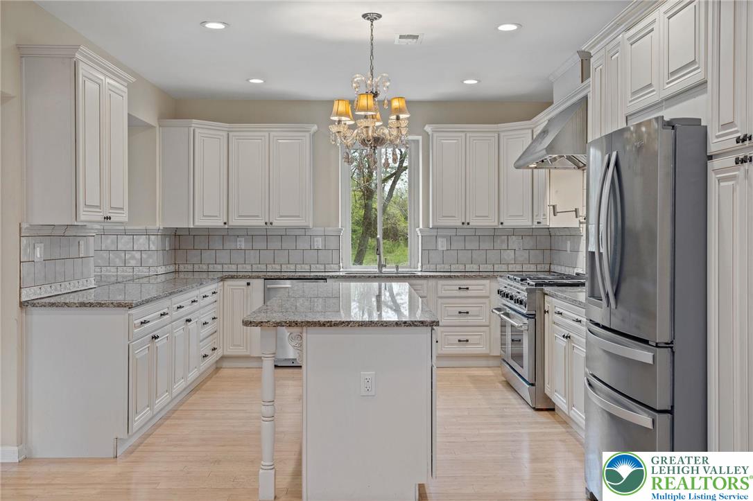 1790 Friedensville Road Bethlehem, PA 18015 - Photo 17 of 50 a kitchen with white cabinets and stainless steel appliances