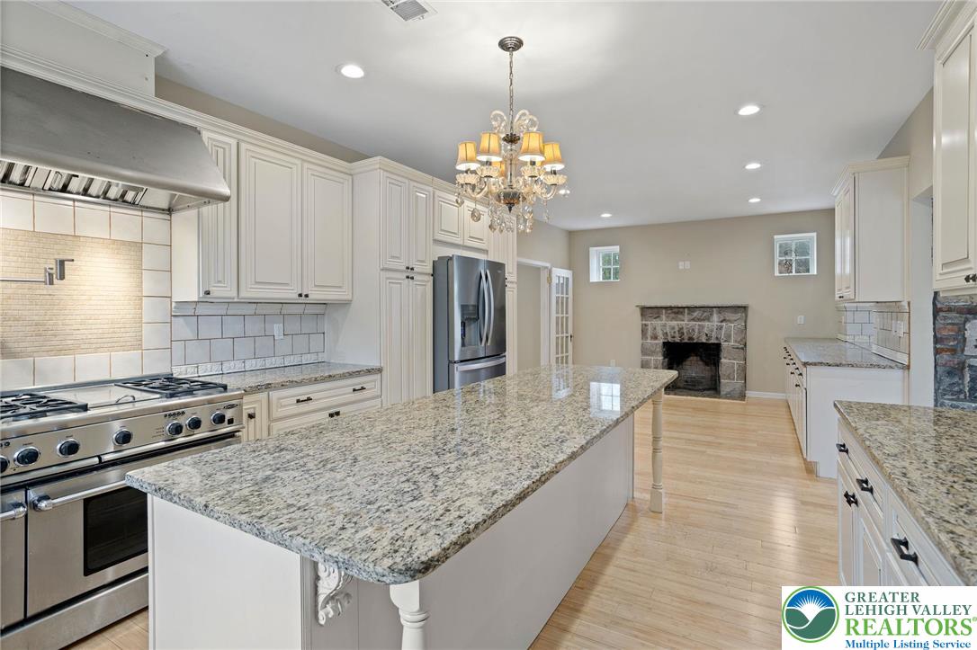 1790 Friedensville Road Bethlehem, PA 18015 - Photo 18 of 50 a kitchen with kitchen island granite countertop a stove and a center island