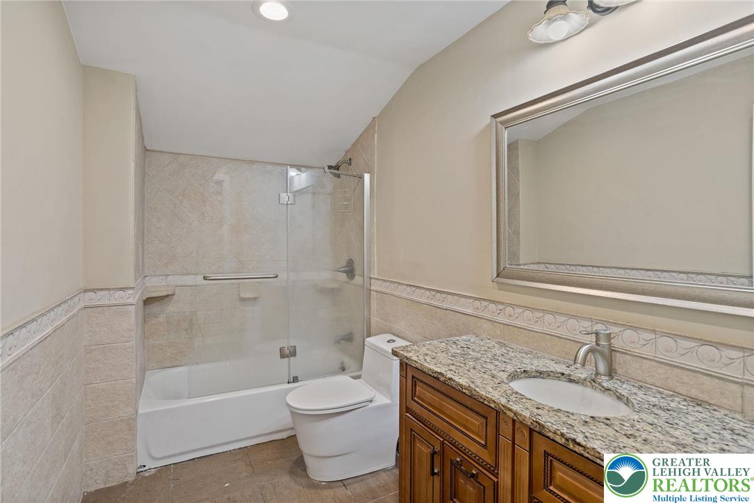1790 Friedensville Road Bethlehem, PA 18015 - Photo 39 of 50 a bathroom with a granite countertop sink a toilet and bathtub