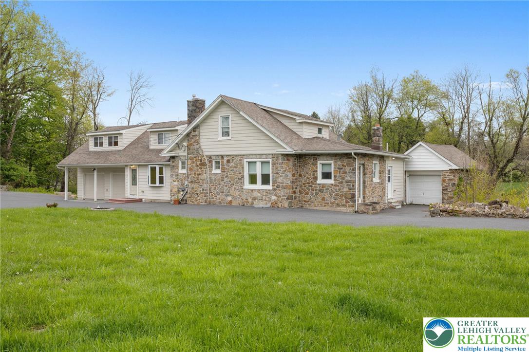 1790 Friedensville Road Bethlehem, PA 18015 - Photo 4 of 50 a front view of a house with a garden and porch
