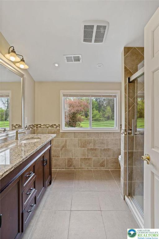 1790 Friedensville Road Bethlehem, PA 18015 - Photo 45 of 50 a bathroom with a granite countertop sink a toilet a mirror and shower