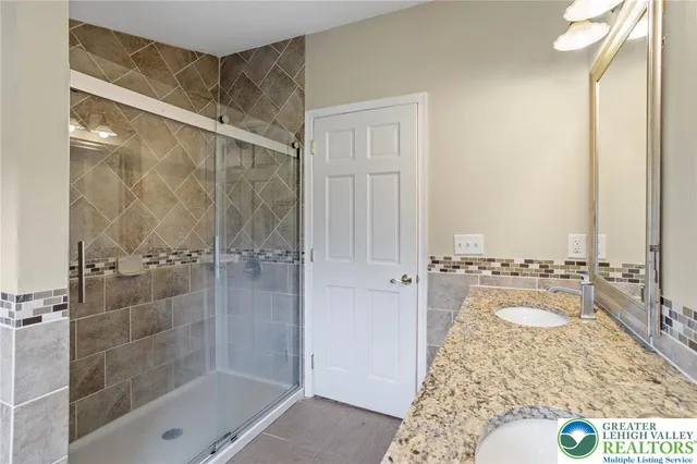 a bathroom with a shower and a sink