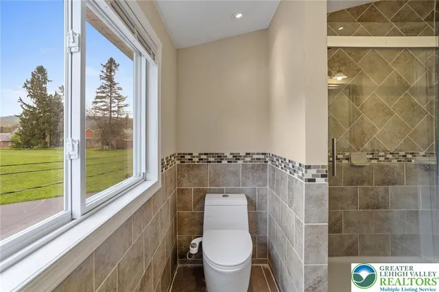 a bathroom with a toilet and a shower