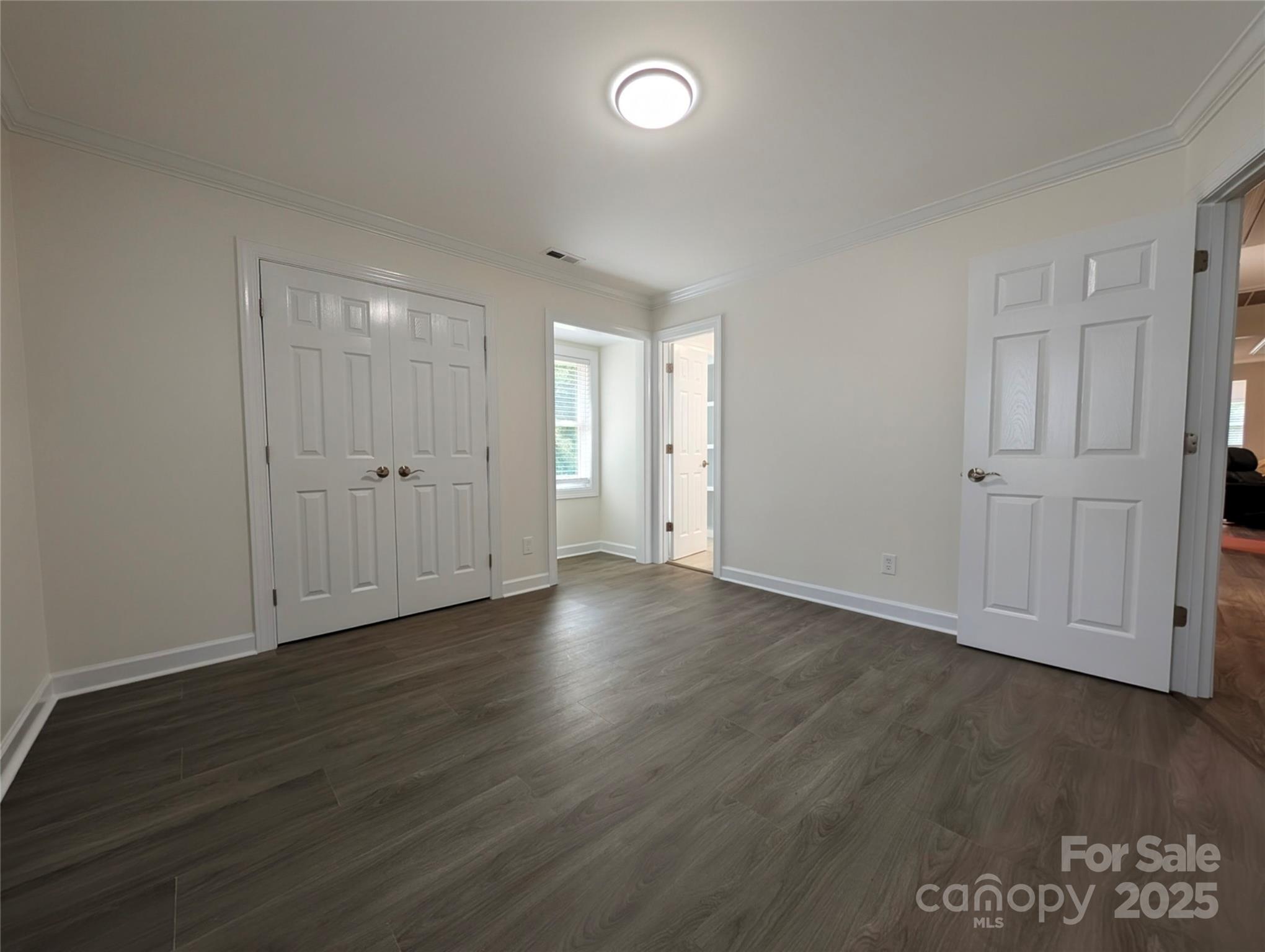 3220 Jonesberry Road Matthews, NC 28105 - Photo 11 of 27 an empty room with wooden floor and white walls