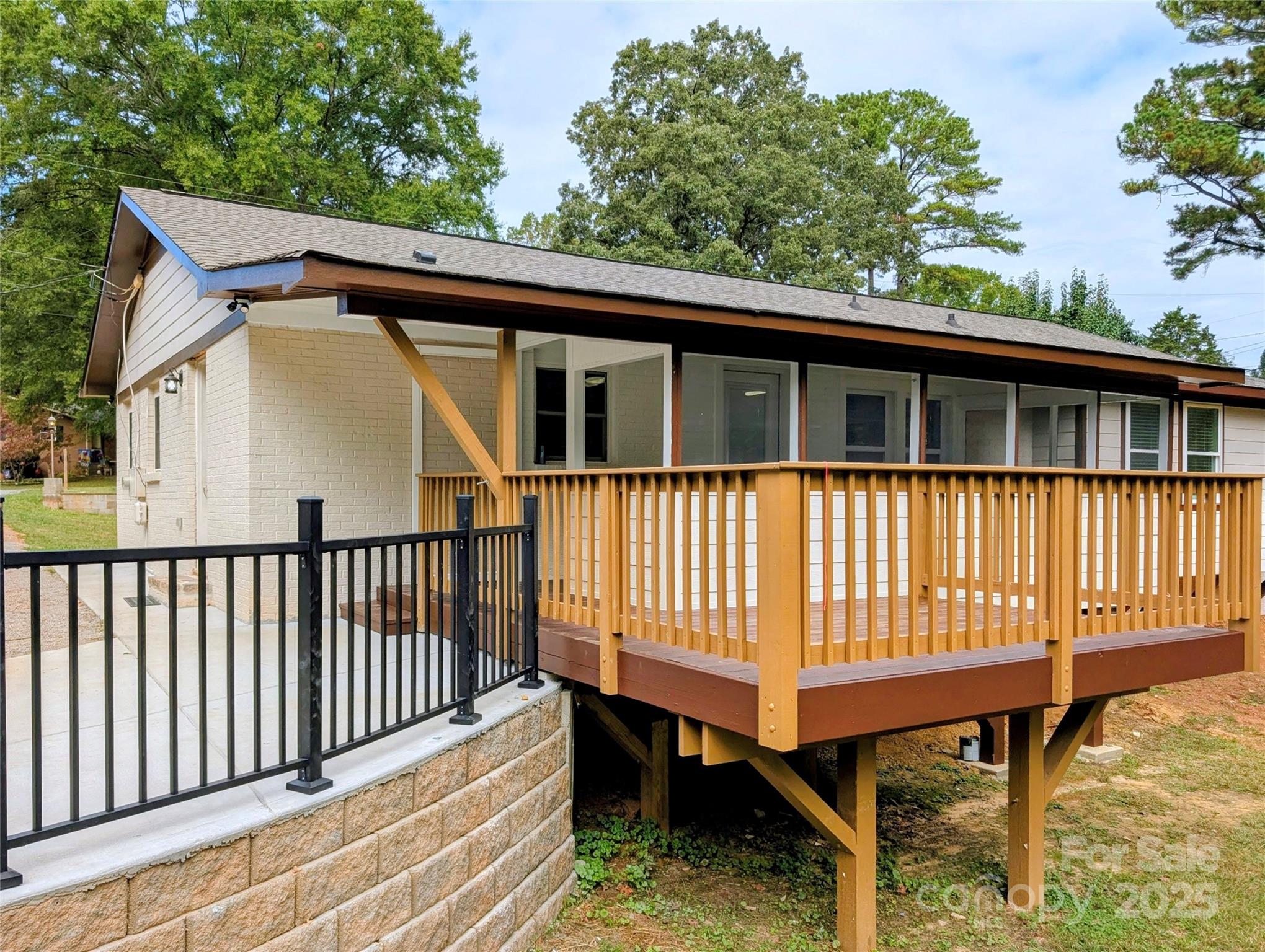 3220 Jonesberry Road Matthews, NC 28105 - Photo 19 of 27 a side view of a house with a wooden deck and furniture