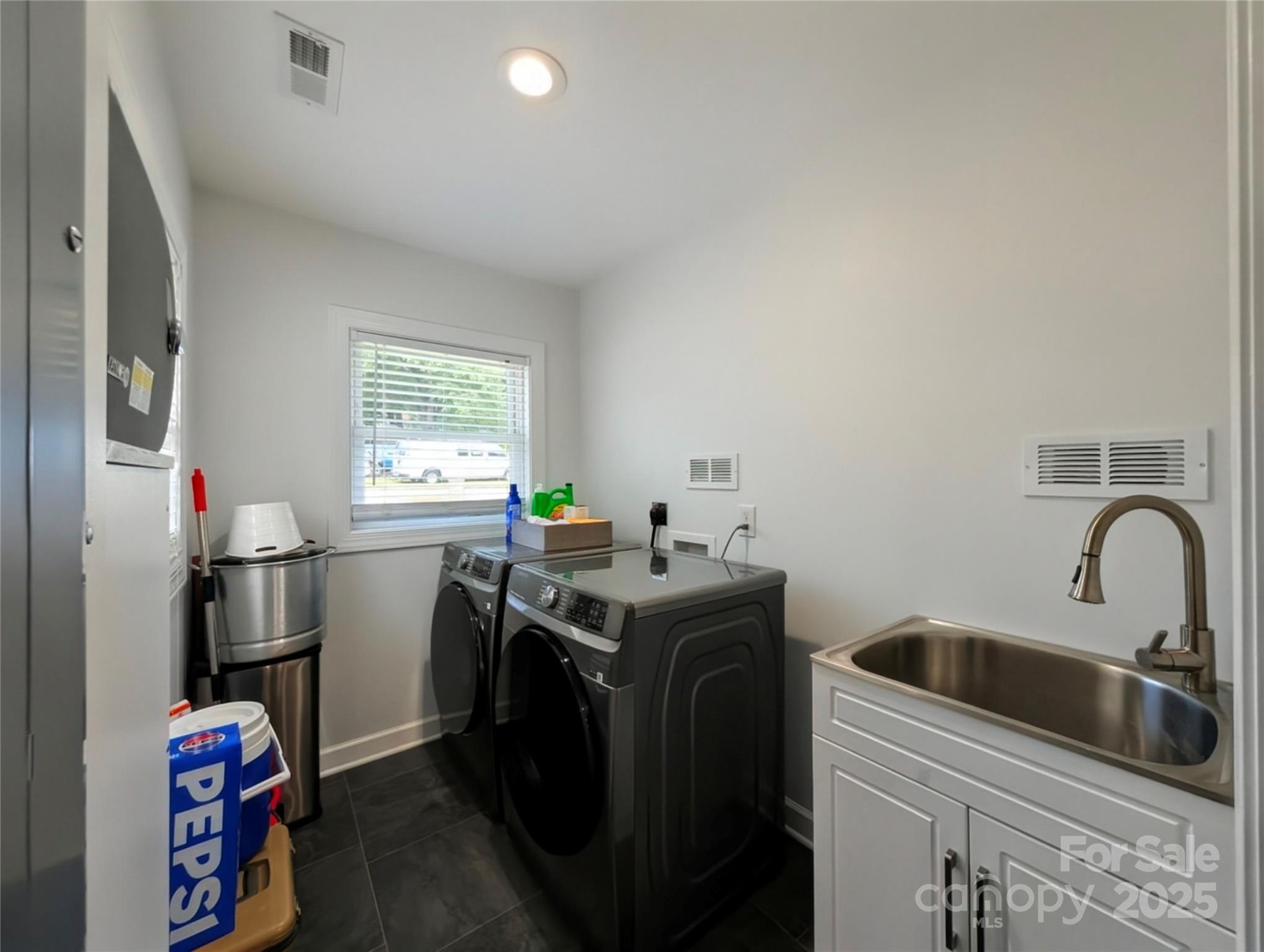3220 Jonesberry Road Matthews, NC 28105 - Photo 22 of 27 a view of a sink and dishwasher with wooden floor
