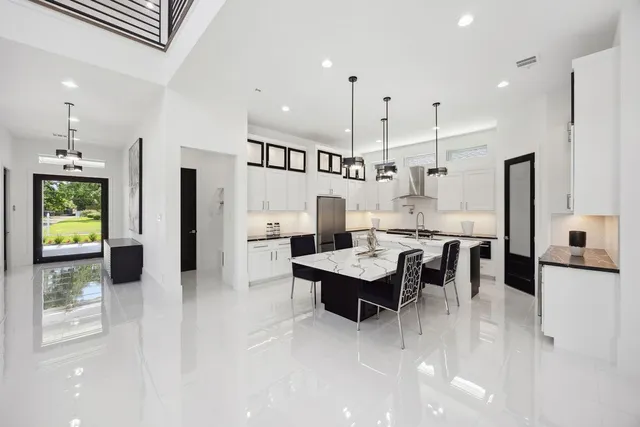 a large kitchen with a table and chairs