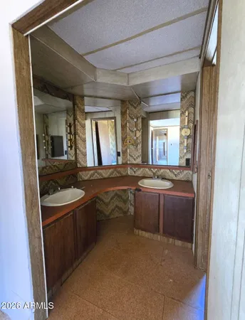 a spacious bathroom with a sink a mirror and a bathtub