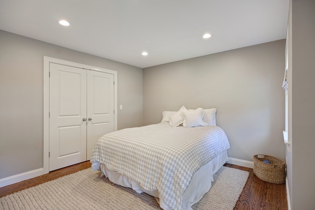 5 Cutler Farm Road Lexington, MA 02421 - Photo 32 of 39 a large bed sitting in a spacious bedroom next to a cabinet