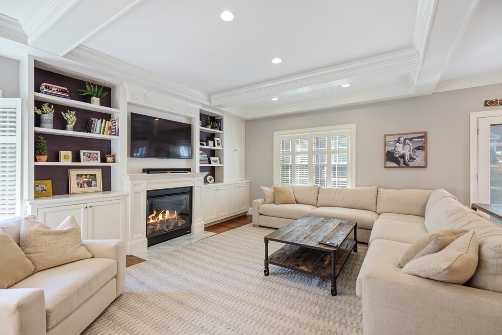 5 Cutler Farm Road Lexington, MA 02421 - Photo 6 of 39 a living room with furniture a fireplace and a flat screen tv