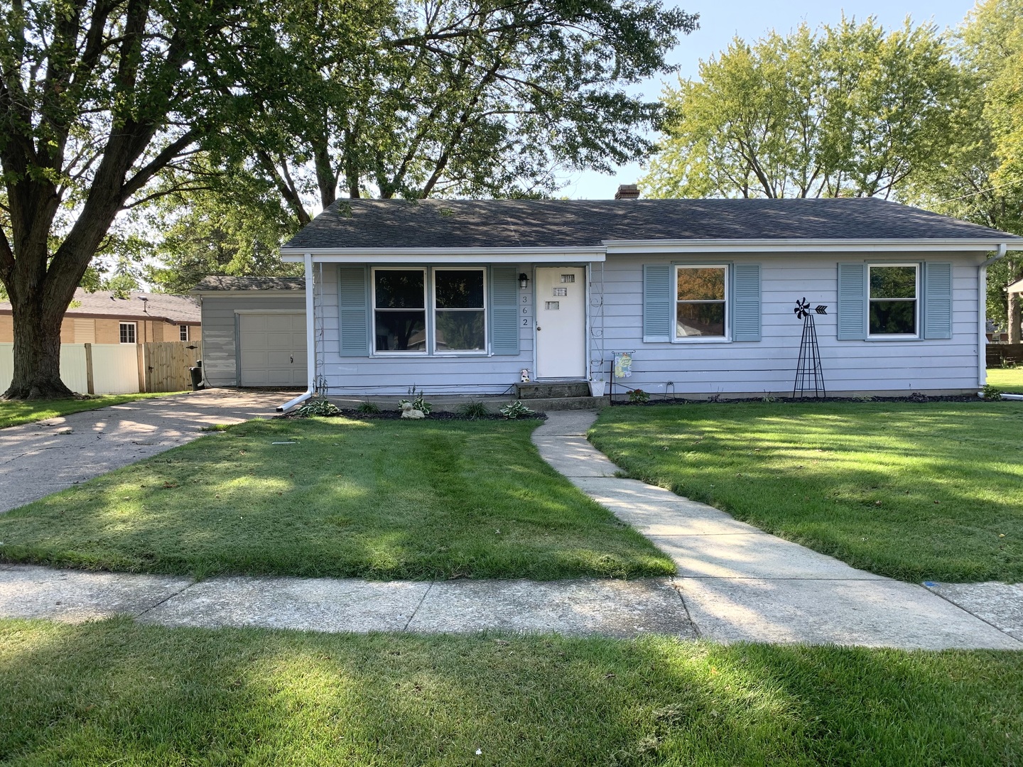 362 Cleveland Avenue Rochelle, IL 61068 - Photo 1 of 12 a front view of a house with a garden