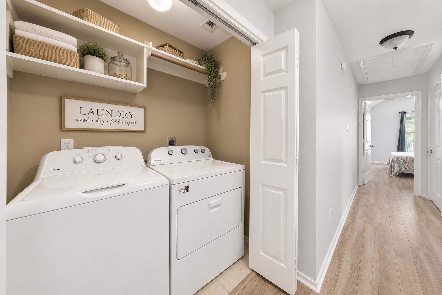 38 Musgrove Place Spring, TX 77382 - Photo 19 of 36 Bright laundry room with built-in shelving, overhead lighting, and easy hallway access for daily convenience.