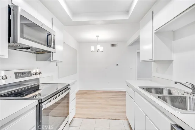 a kitchen with stainless steel appliances granite countertop a sink and a stove