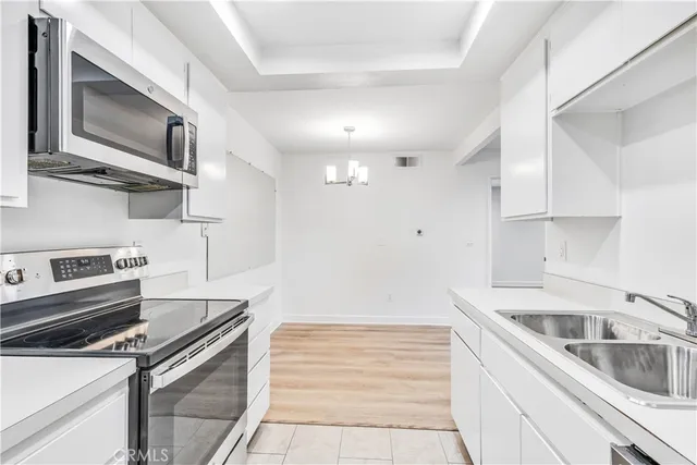 a kitchen with a sink stove and microwave