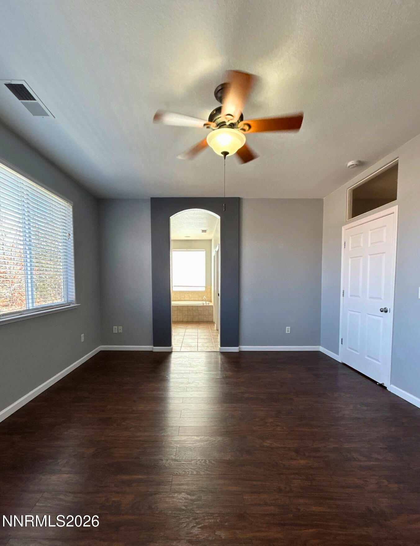 1783 Back Country Road Reno, NV 89521 - Photo 13 of 26 a view of an empty room with a window and wooden floor