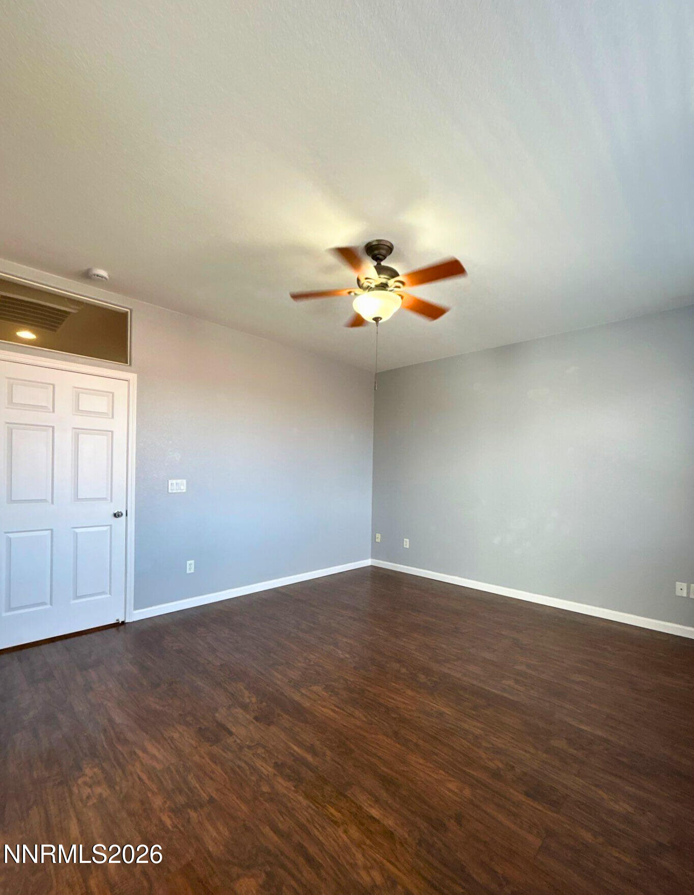 1783 Back Country Road Reno, NV 89521 - Photo 14 of 26 an empty room with wooden floor and chandelier fan