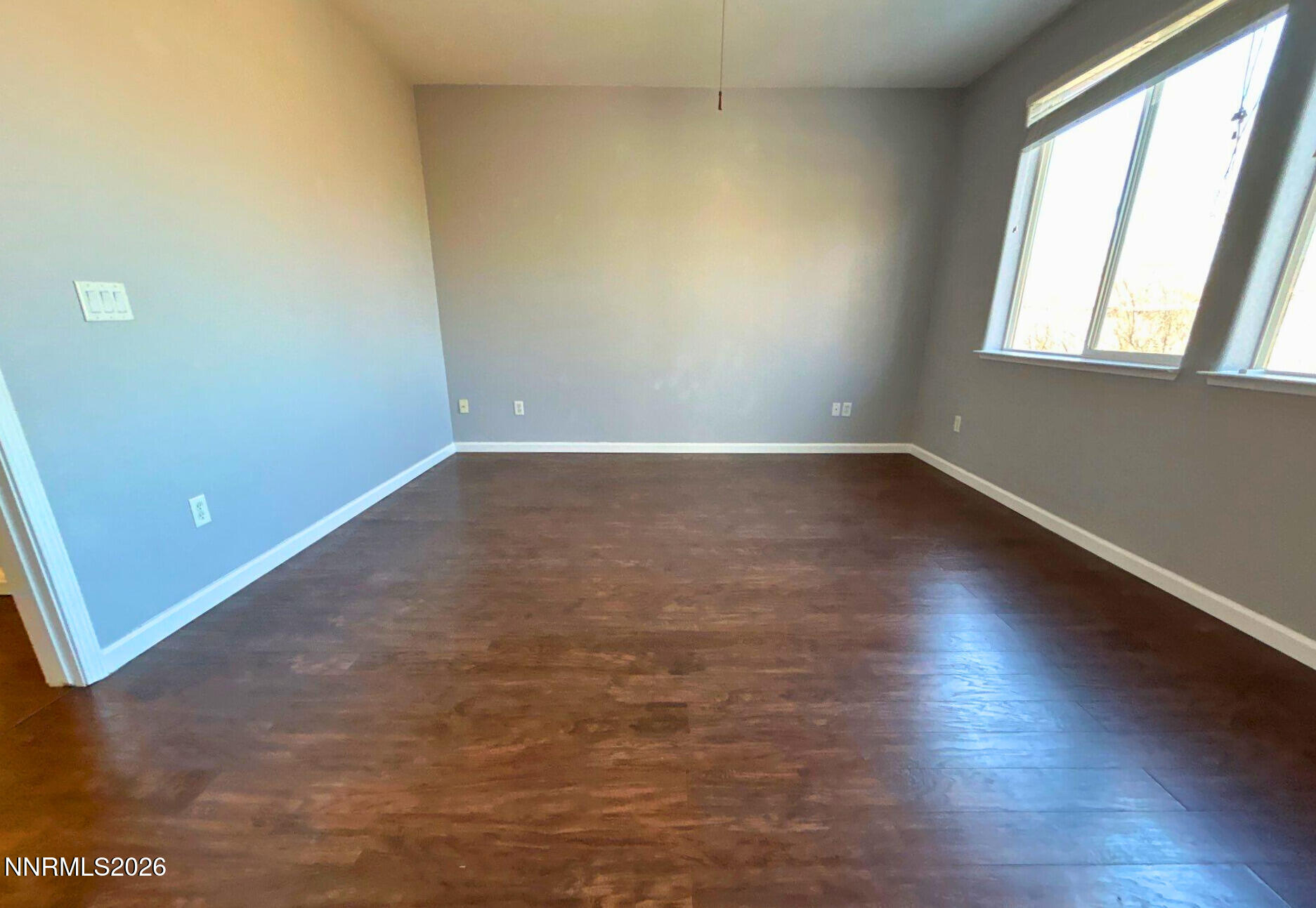 1783 Back Country Road Reno, NV 89521 - Photo 16 of 28 an empty room with wooden floor and windows