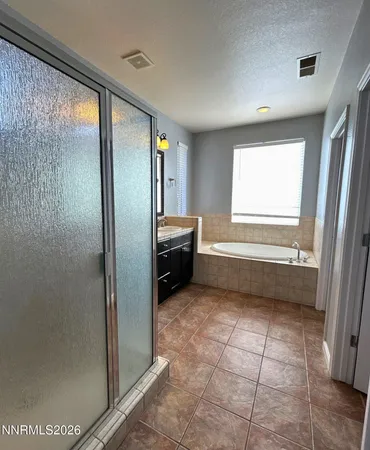 a view of a bathroom with mirror and shower