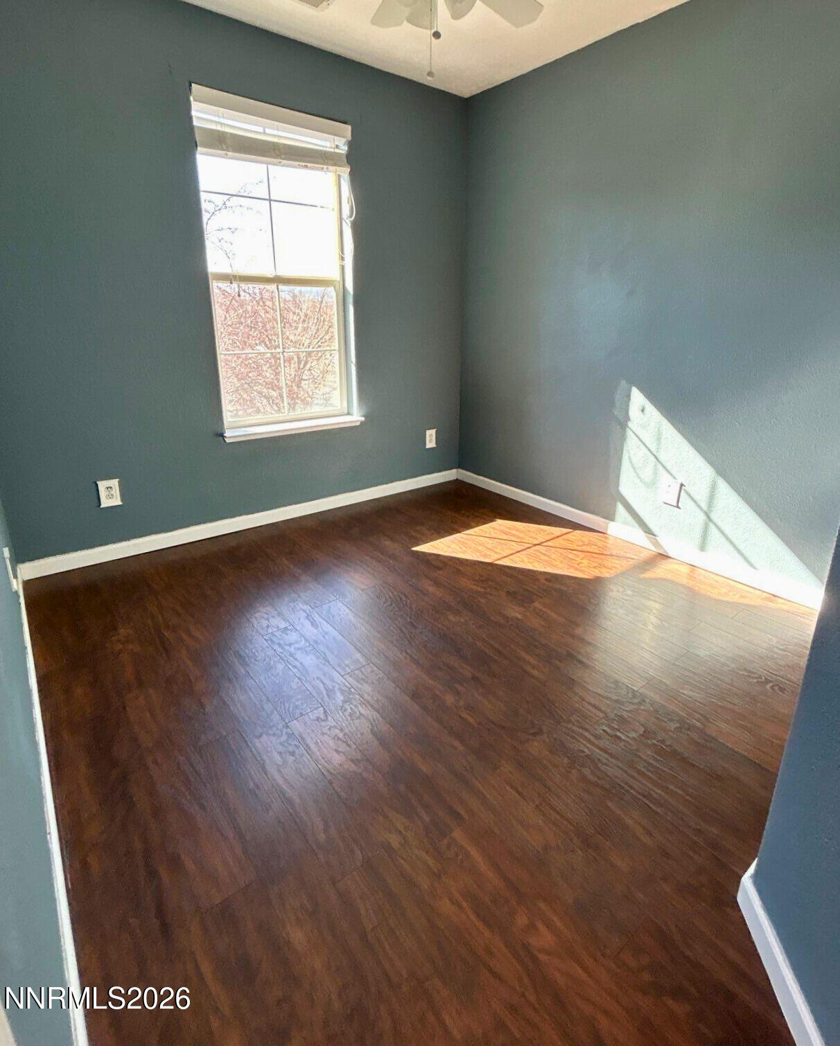 1783 Back Country Road Reno, NV 89521 - Photo 22 of 28 an empty room with wooden floor and windows