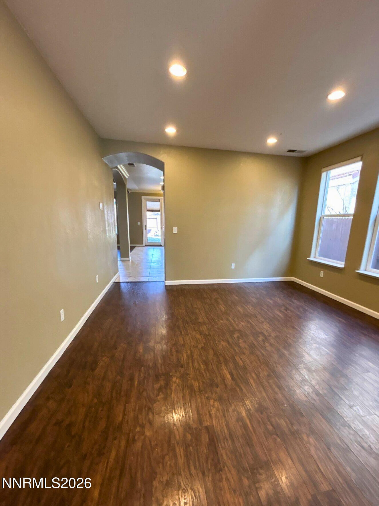 1783 Back Country Road Reno, NV 89521 - Photo 6 of 28 an empty room with wooden floor and windows