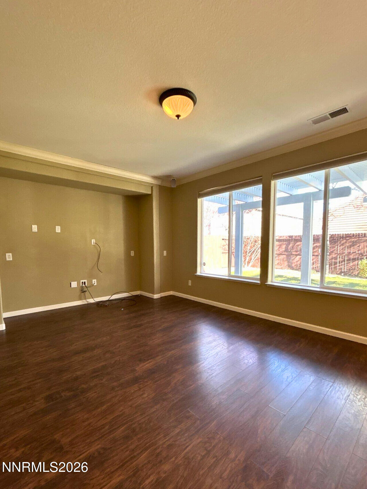 1783 Back Country Road Reno, NV 89521 - Photo 6 of 26 an empty room with wooden floor and windows