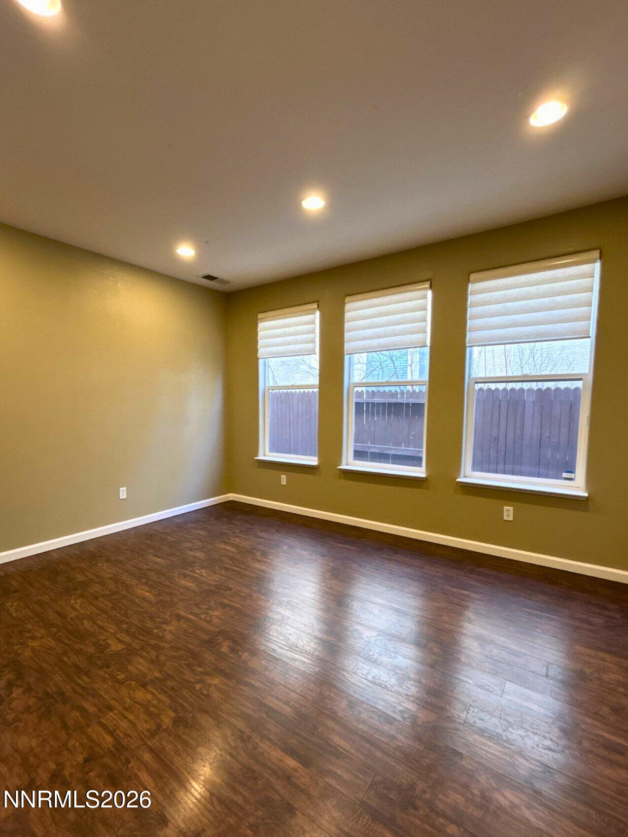 1783 Back Country Road Reno, NV 89521 - Photo 9 of 26 an empty room with wooden floor and windows