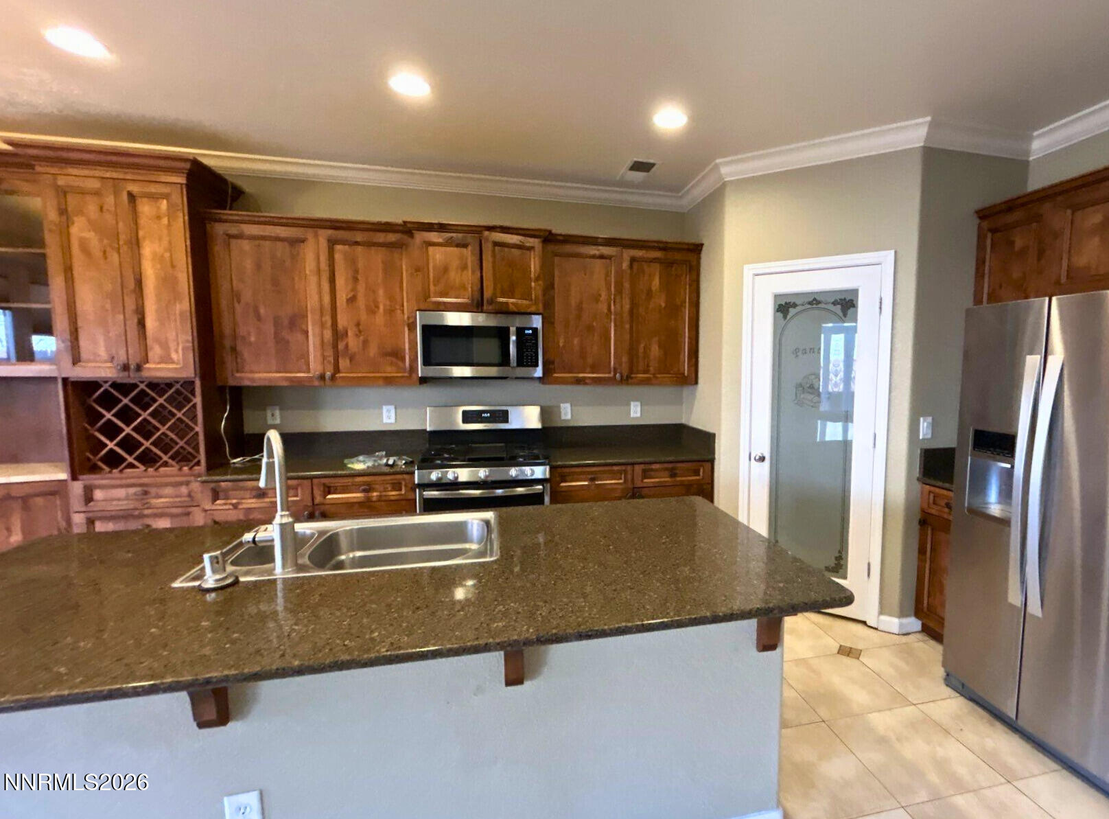 1783 Back Country Road Reno, NV 89521 - Photo 9 of 28 a kitchen with stainless steel appliances granite countertop a refrigerator a stove and a sink with granite countertops